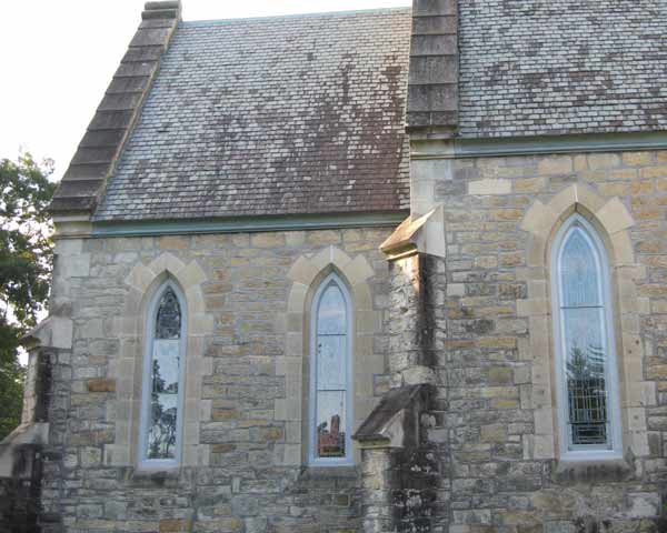 Exterior of same building - new clear safety glass allows the windows to be seen. The exterior of the building appears more appealing and clean.