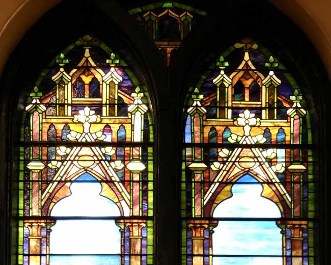 pieces of a stained glass window laid on a worktable to be re-leaded