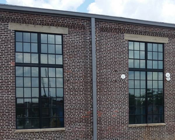 Exterior of same building - new clear safety glass allows the windows to be seen. The exterior of the building appears more appealing and clean.