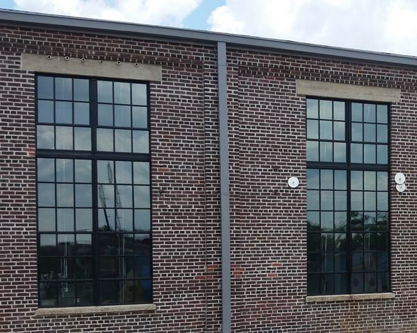 Exterior of same building - new clear safety glass allows the windows to be seen.  The exterior of the building appears more appealing and clean.