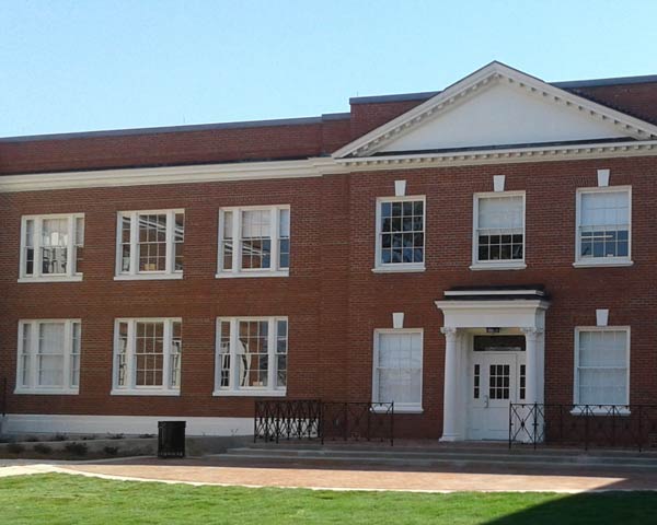 Brick building with many white wood-framed windows