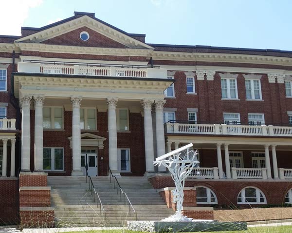 Brick building with many wood windows in beautiful condition